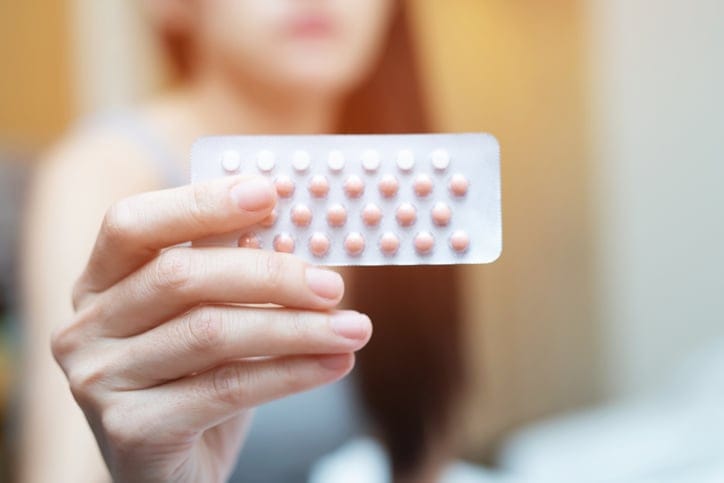Woman with her birth control tablets.