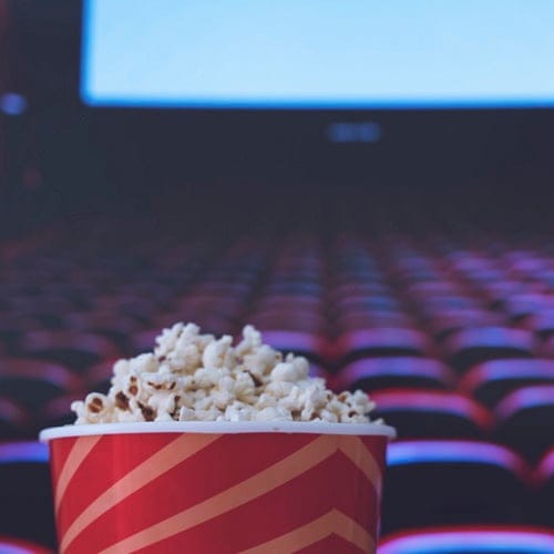 A tub of popcorn at the movies.