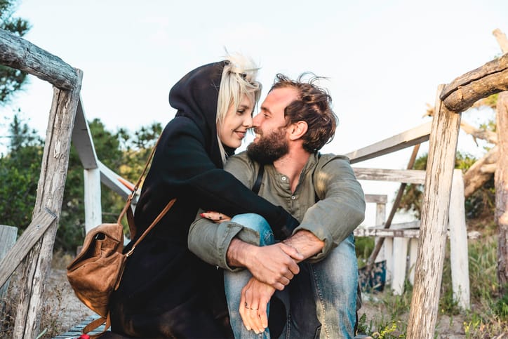 couple sitting on a bridge