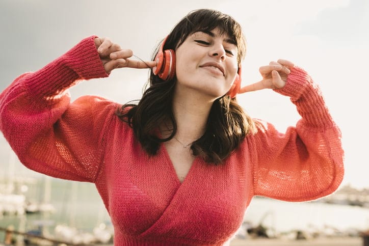 Woman listening to music with headset.