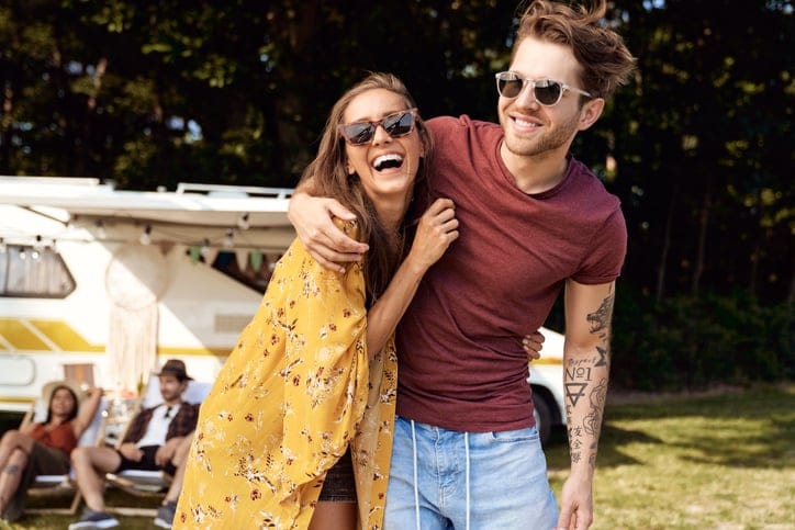 young couple hugging outside