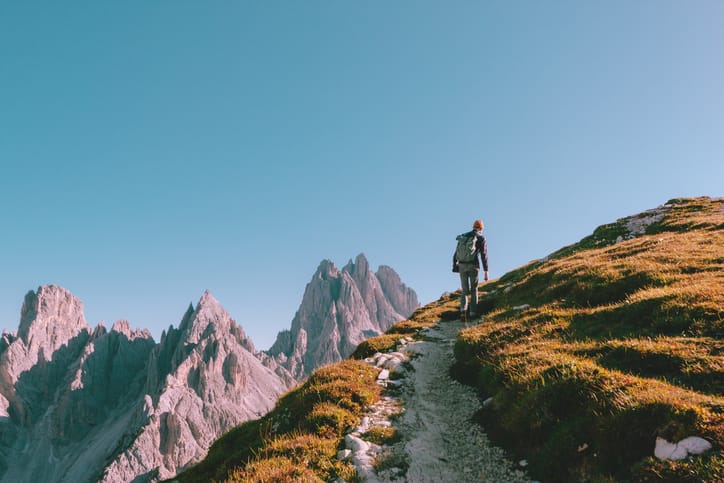 Man climbing up a mountain.