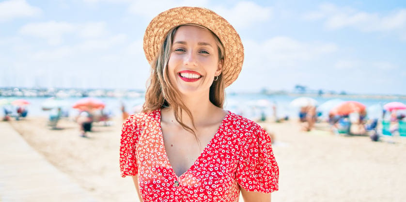 girl smiling beach red dress