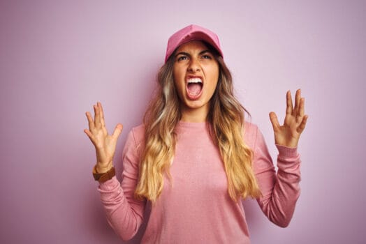 Young woman with a crazy expression on her face.