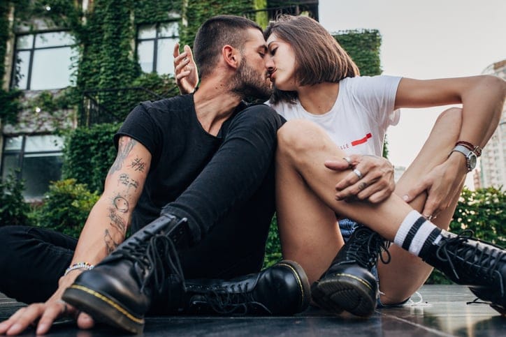 trendy couple kissing outdoors