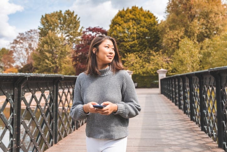 young woman walking in park
