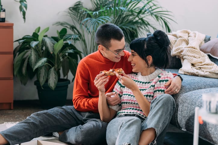 Couple sharing homemade Pizza.