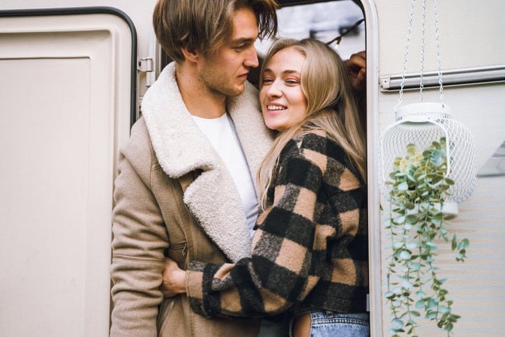 happy couple embracing in van