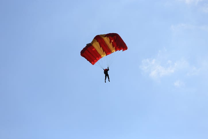 Parasailing in blue skies.
