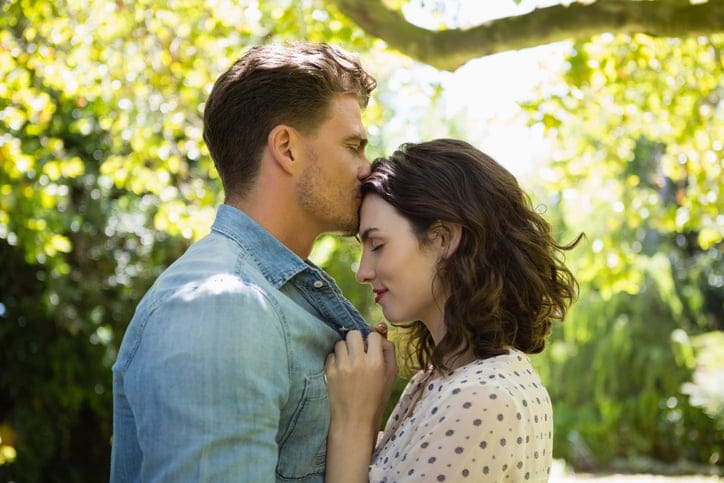 couple kissing in the trees