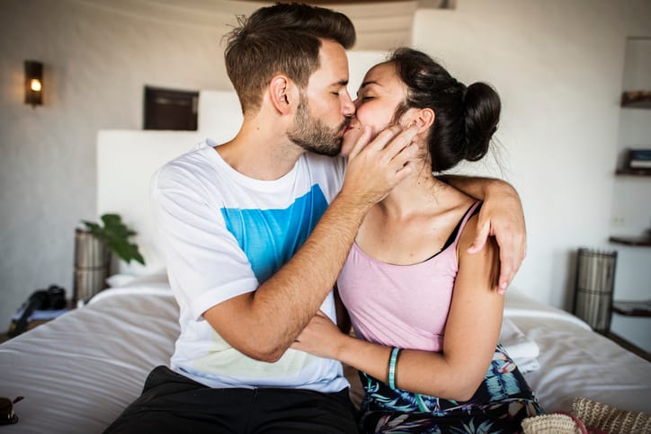 couple kissing bedroom