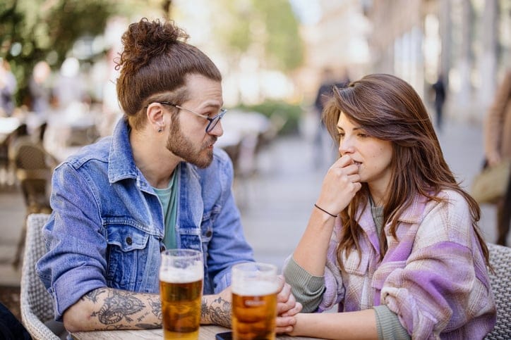 Unhappy couple arguing at cafe.