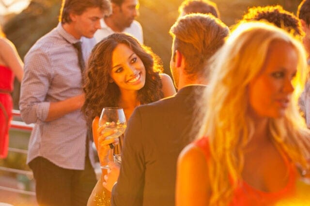 couple flirting at rooftop party