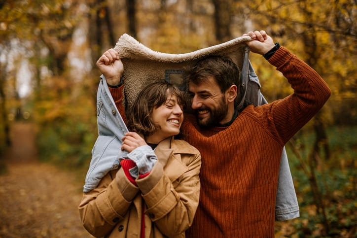 couple walking in autumn forest