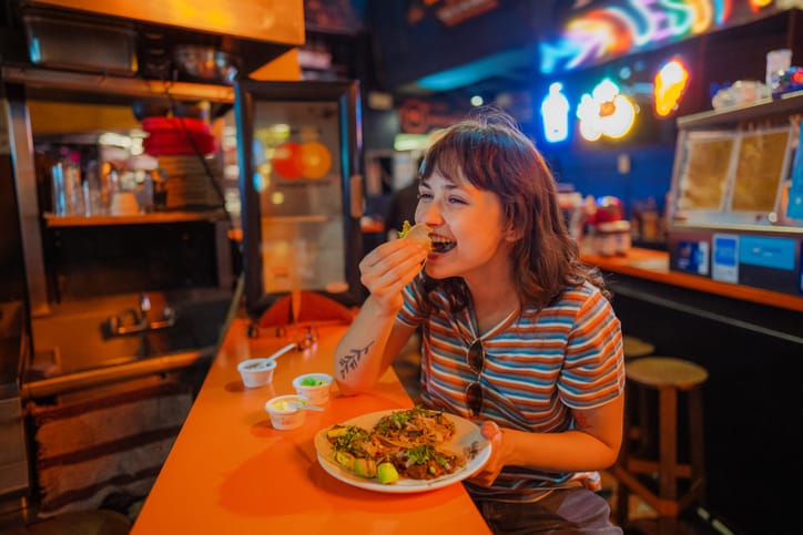 happy women eating at taco bar