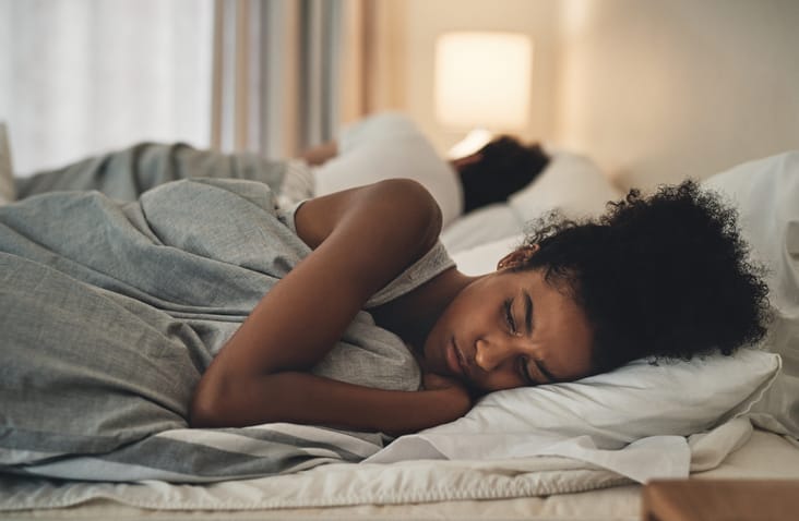 frustrated woman lying in bed