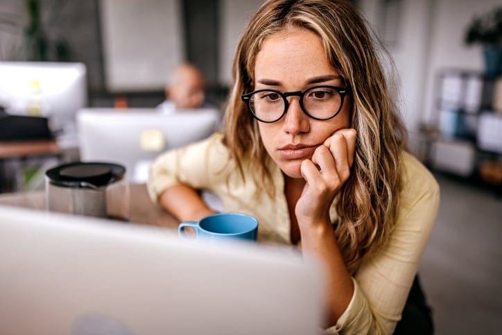 bored woman staring at laptop