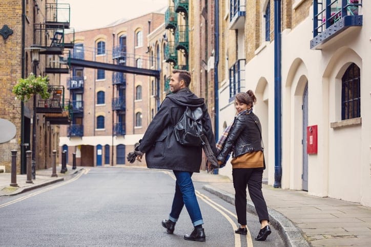 happy couple walking through city