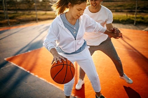 couple playing basketball together