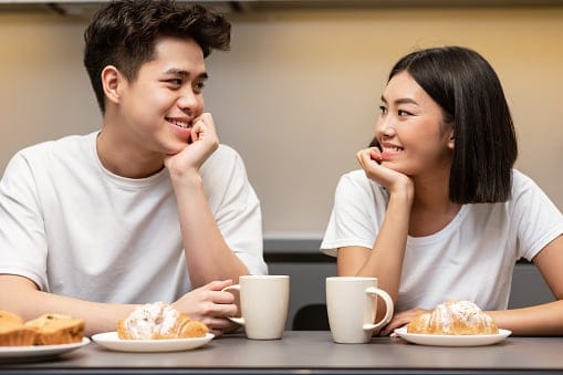 Couple enjoying coffee and a snack.