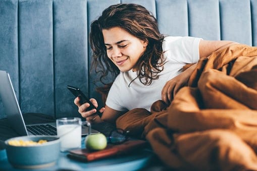 Woman having breakfast in bed.