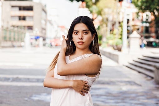 serious woman standing in street