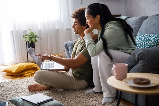 Millennial couple looking at their finances via online banking