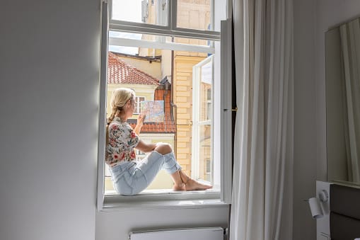 Young woman in hotel room looking at city map.