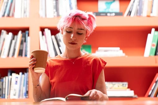 girl reading book in library