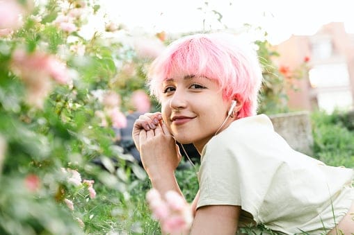 Happy woman enjoying her free time while lying on grass