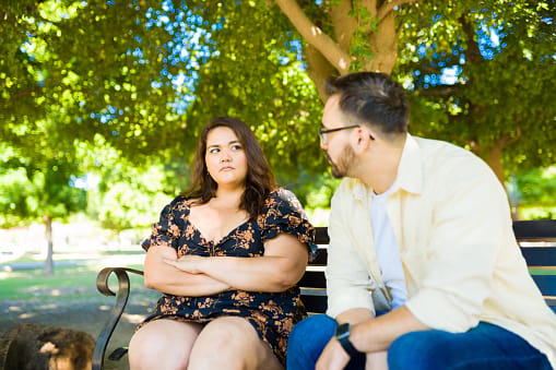 upset girlfriend with boyfriend on bench