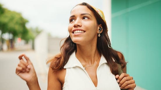Woman listens to music in wireless headphones.
