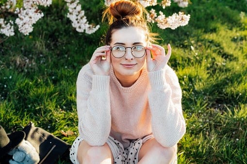 Young smiling hipster girl in glasses.