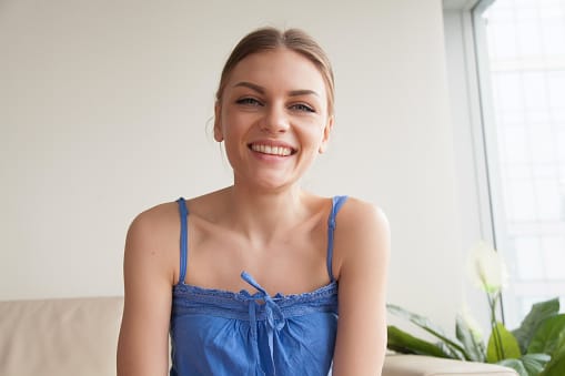 smiling woman in blue dress