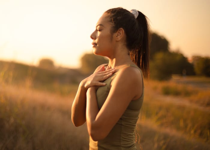 woman meditating during sunrise