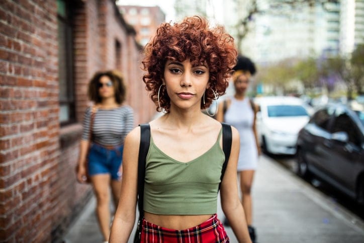 woman walking with attitude through city