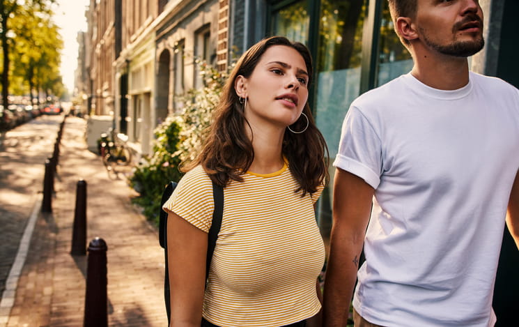 couple walking hand in hand down the street