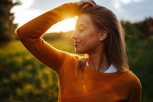 Young woman enjoying sunset.