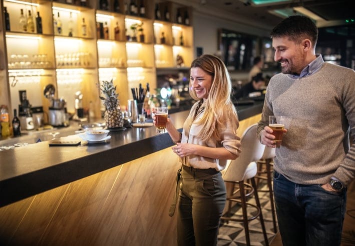 guy checking out woman at bar