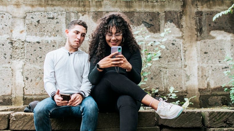 Woman looking at her husband's phone.