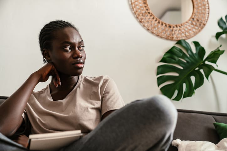 woman on couch looking out window