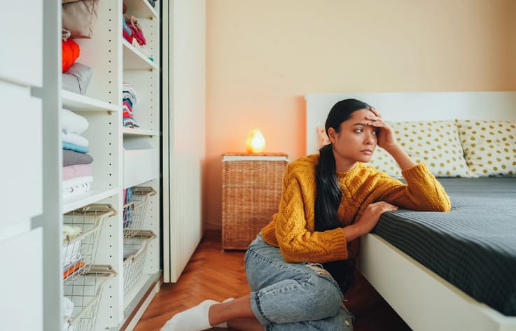 depressed woman in her bedroom