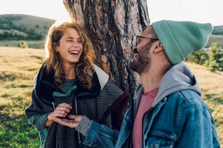 Couple hanging out on a sunny hike.