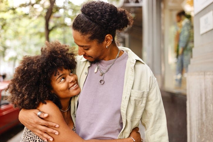 couple in love walking down city block