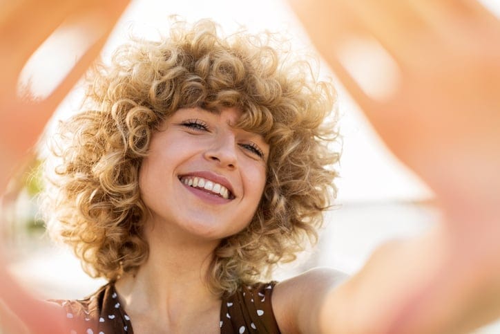 Portrait of young woman with curly hair