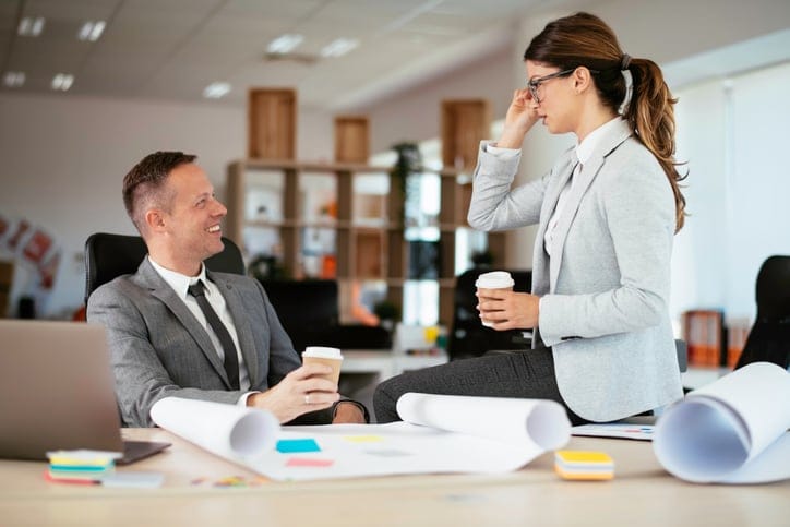 man woman business talking at work