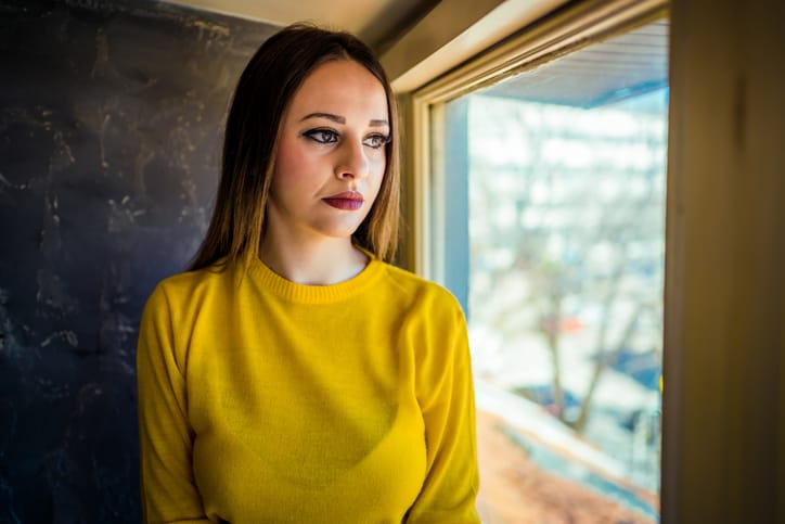 Woman looking through the window.