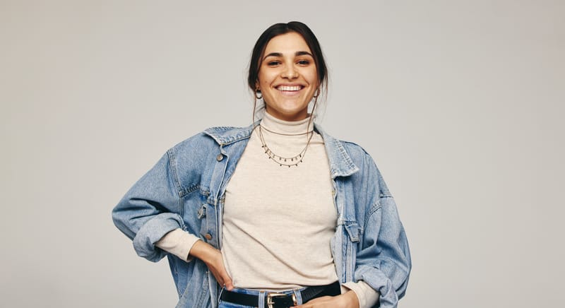smiling woman with hand on hip