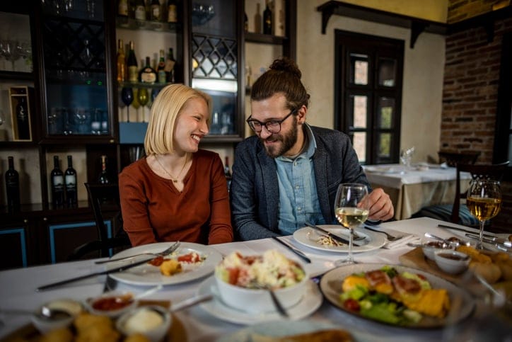 Photo of young couple having date at restaurant