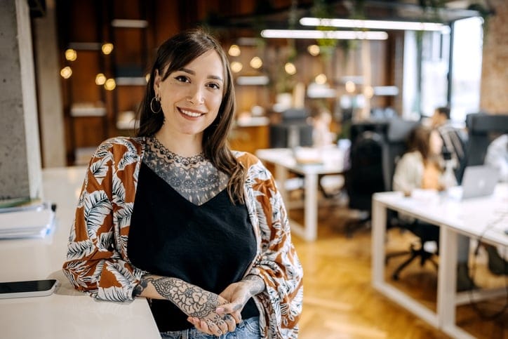 tattooed woman in office